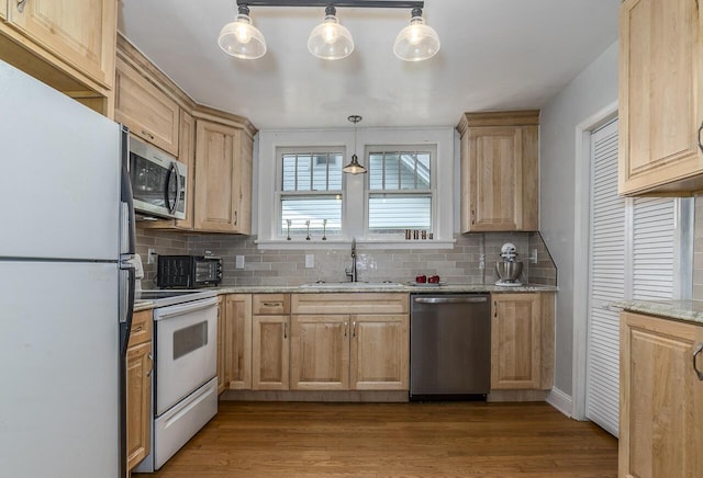 2506 Rosalind Ave SW, Roanoke, VA 24014 - kitchen featuring stainless steel appliances, light brown cabinetry, tasteful backsplash, and light wood-style floors