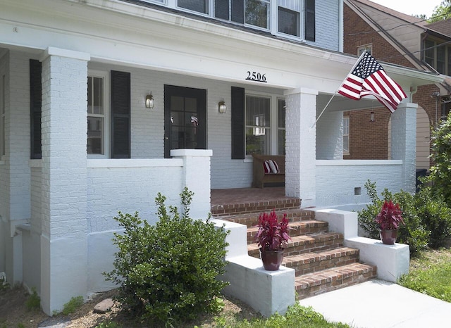 2506 Rosalind Ave SW, Roanoke, VA 24014 - property entrance featuring a porch and brick siding