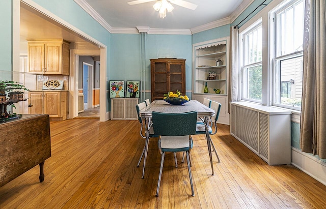 2506 Rosalind Ave SW, Roanoke, VA 24014 - dining space with light wood-style floors, ceiling fan, ornamental molding, and radiator heating unit