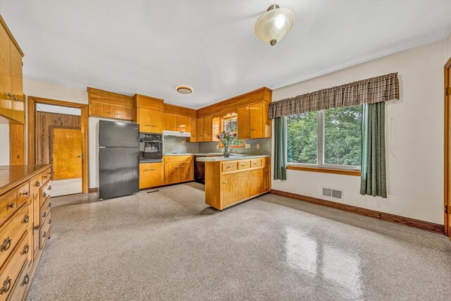 4362 Fontaine Cir, Roanoke, VA 24018 - kitchen featuring black appliances, a peninsula, brown cabinetry, under cabinet range hood, and light countertops
