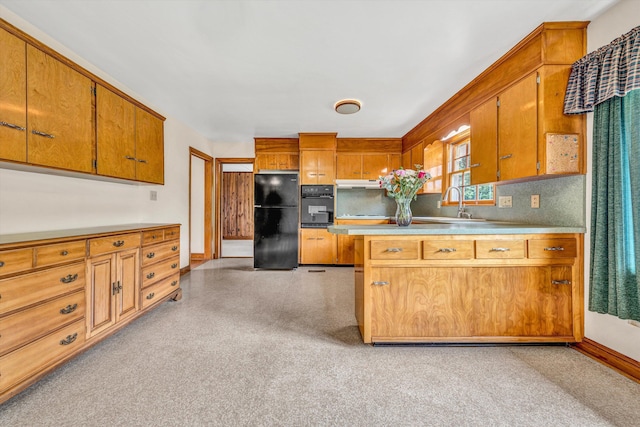 4362 Fontaine Cir, Roanoke, VA 24018 - kitchen with black appliances, brown cabinets, under cabinet range hood, light countertops, and a peninsula
