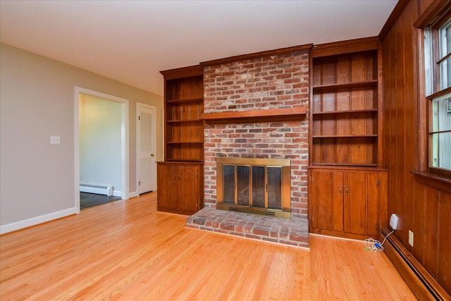 115 Bartley Dr, Salem, VA 24153 - unfurnished living room with a baseboard radiator, a fireplace, wood finished floors, and built in shelves