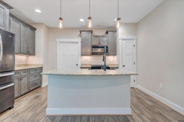 3141 Trinity Rd, Troutville, VA 24175 - kitchen featuring stainless steel appliances, light wood finished floors, light stone counters, and recessed lighting