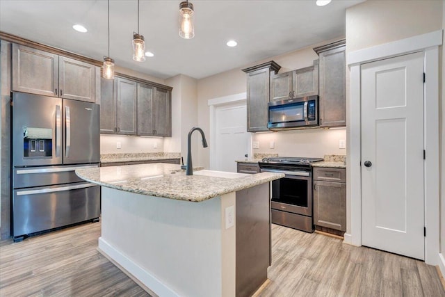 3141 Trinity Rd, Troutville, VA 24175 - kitchen with stainless steel appliances, light wood-type flooring, light stone countertops, a kitchen island with sink, and recessed lighting