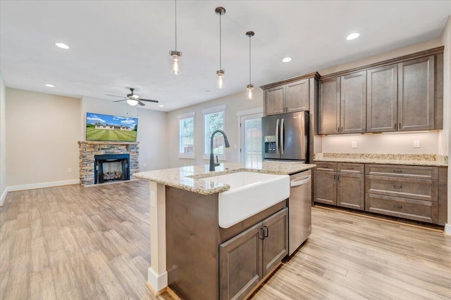 3141 Trinity Rd, Troutville, VA 24175 - kitchen featuring appliances with stainless steel finishes, a ceiling fan, light wood-style flooring, decorative light fixtures, and open floor plan