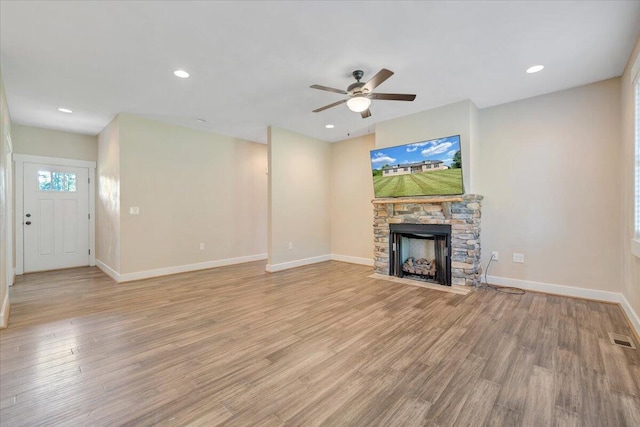3141 Trinity Rd, Troutville, VA 24175 - unfurnished living room featuring a stone fireplace, a ceiling fan, light wood-type flooring, and recessed lighting
