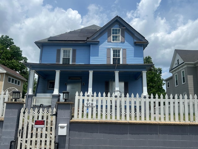 918 Dale Ave SE, Roanoke, VA 24013 - view of front of house featuring covered porch, a fenced front yard, a gate, and roof mounted solar panels