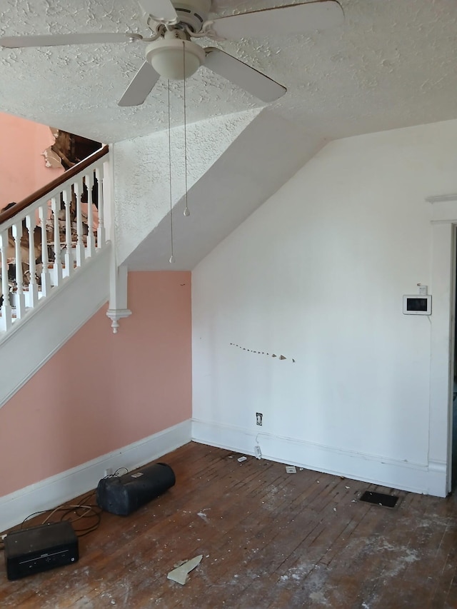 918 Dale Ave SE, Roanoke, VA 24013 - unfurnished living room with wood-type flooring, ceiling fan, vaulted ceiling, a textured ceiling, and stairway