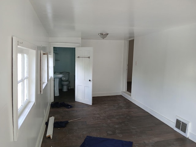 918 Dale Ave SE, Roanoke, VA 24013 - unfurnished bedroom featuring multiple windows and dark wood-style floors