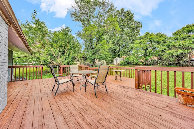 3717 Martinell Ave, Roanoke, VA 24018 - wooden deck with a storage unit, outdoor dining area, a lawn, and view of scattered trees