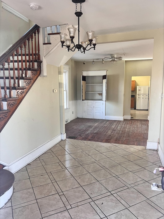 906 5th St SE, Roanoke, VA 24013 - unfurnished dining area with tile patterned floors, a chandelier, stairway, rail lighting, and ceiling fan