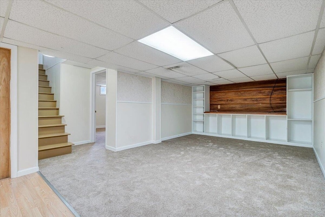 618 Gladies St NW, Roanoke, VA 24017 - finished below grade area featuring stairway, built in shelves, carpet, wood finished floors, and a drop ceiling