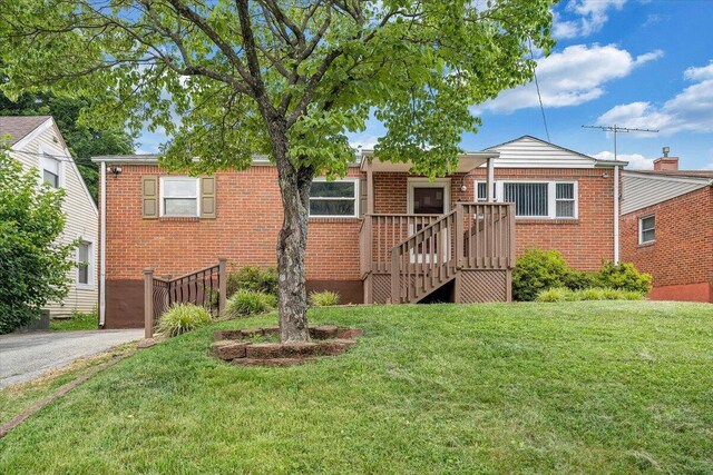 618 Gladies St NW, Roanoke, VA 24017 - view of front of home with brick siding, a front yard, and driveway