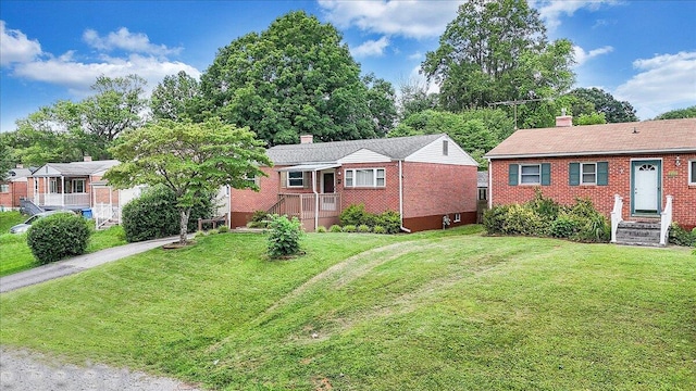 618 Gladies St NW, Roanoke, VA 24017 - view of front of home with a chimney, brick siding, and a front yard