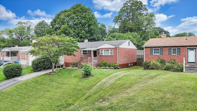 618 Gladies St NW, Roanoke, VA 24017 - view of front of home with a chimney, brick siding, and a front lawn