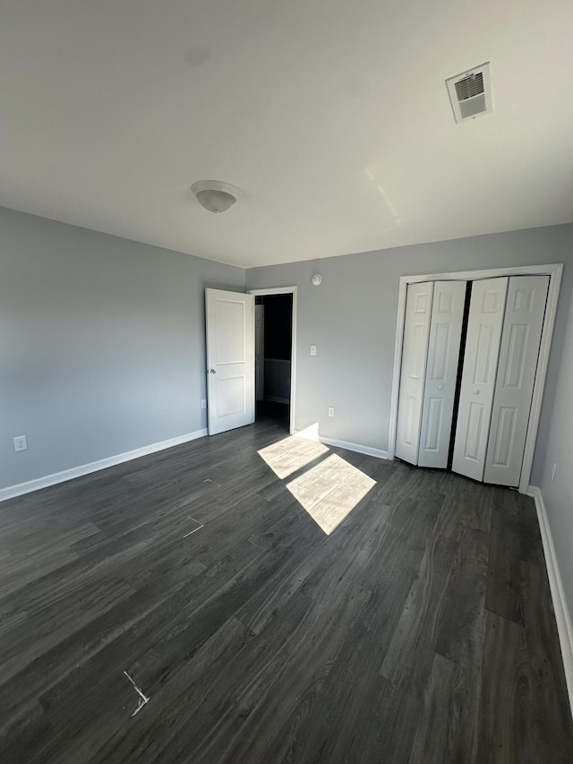1626 9th St SE, Roanoke, VA 24013 - unfurnished bedroom with dark wood finished floors and a closet
