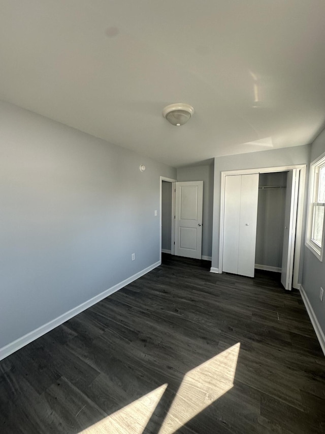 1626 9th St SE, Roanoke, VA 24013 - unfurnished bedroom with dark wood finished floors and a closet