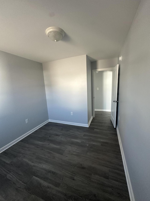 1626 9th St SE, Roanoke, VA 24013 - spare room featuring baseboards and dark wood-style floors