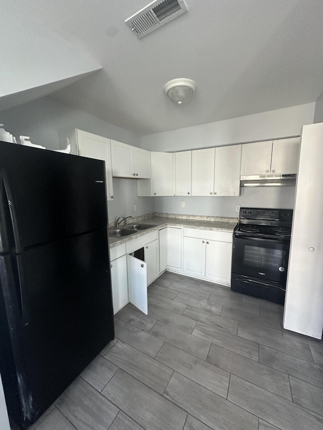 1626 9th St SE, Roanoke, VA 24013 - kitchen featuring black appliances, light countertops, white cabinets, and wood finish floors