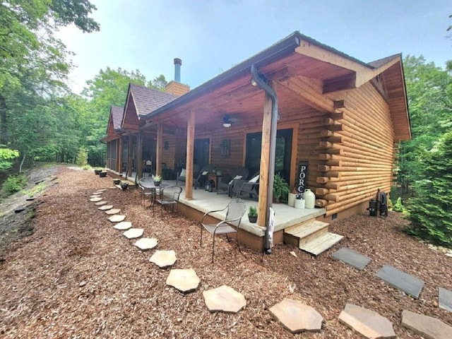 350 Sizer Ln, New Castle, VA 24127 - rear view of house with log exterior, a patio, a chimney, and a sunroom