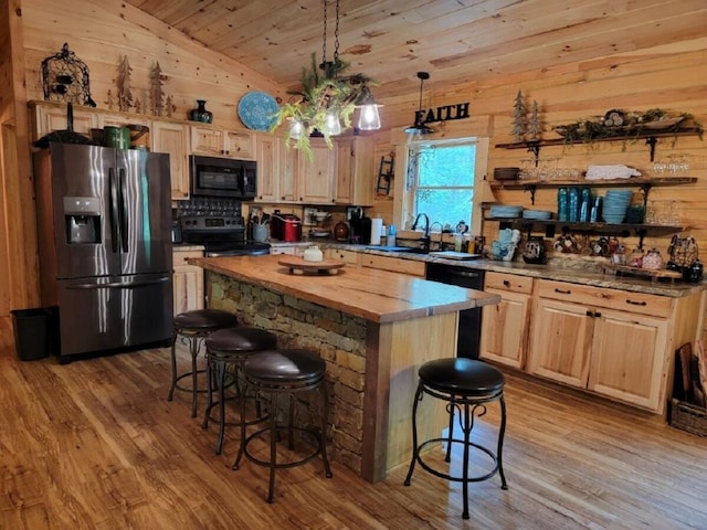 350 Sizer Ln, New Castle, VA 24127 - kitchen featuring black appliances, light brown cabinets, a kitchen breakfast bar, light wood finished floors, and vaulted ceiling
