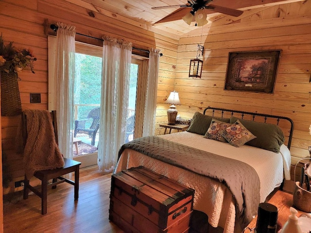 350 Sizer Ln, New Castle, VA 24127 - bedroom featuring wooden walls, wood finished floors, lofted ceiling, and access to exterior
