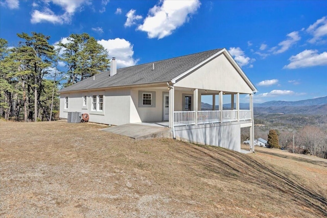 2534 Paris Mountain Rd, Elliston, VA 24087 - rear view of house featuring a chimney, a mountain view, stucco siding, and covered porch
