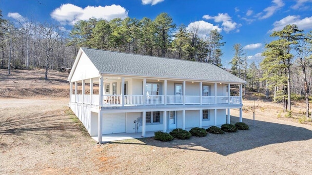 2534 Paris Mountain Rd, Elliston, VA 24087 - view of front facade with an attached garage, a shingled roof, covered porch, and dirt driveway