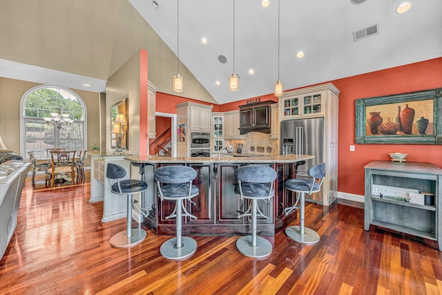 325 Bull Run Trl, Penhook, VA 24137 - kitchen featuring dark wood finished floors, light stone counters, a breakfast bar area, glass insert cabinets, and appliances with stainless steel finishes