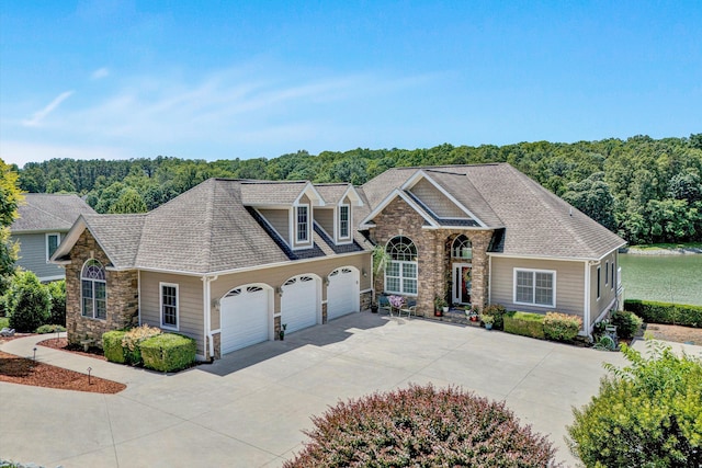 325 Bull Run Trl, Penhook, VA 24137 - view of front of property with stone siding, an attached garage, driveway, a forest view, and a shingled roof