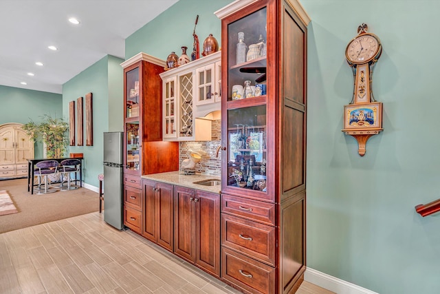 325 Bull Run Trl, Penhook, VA 24137 - kitchen featuring freestanding refrigerator, decorative backsplash, light stone countertops, recessed lighting, and glass insert cabinets