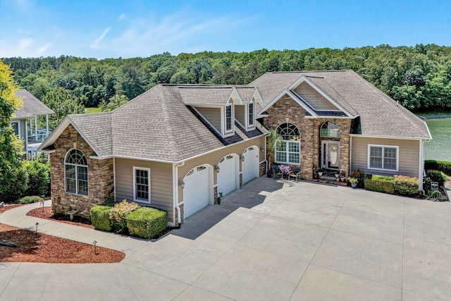 325 Bull Run Trl, Penhook, VA 24137 - view of front of house featuring an attached garage, driveway, stone siding, and a shingled roof