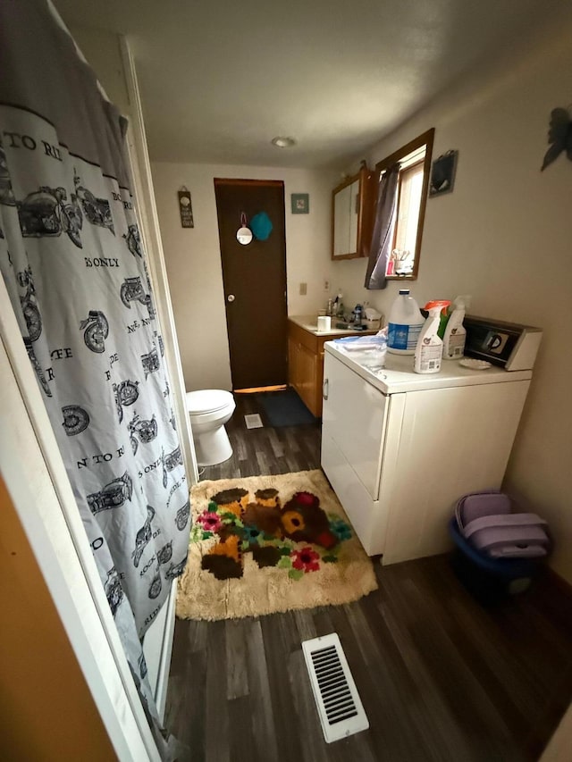 2612 Webster Rd, Roanoke, VA 24012 - bathroom with washer / clothes dryer, wood finished floors, vanity, and a shower with curtain