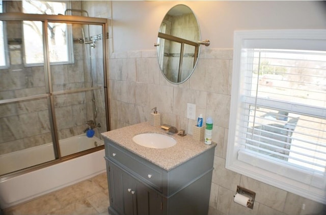 1138 Montrose Ave SE, Roanoke, VA 24013 - full bathroom featuring tile walls, enclosed tub / shower combo, and vanity