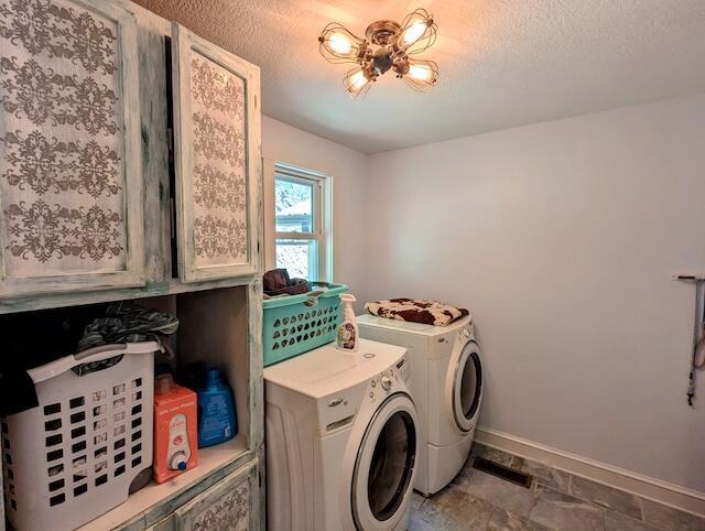 221 Camp Creek Rd NW, Riner, VA 24149 - washroom featuring washing machine and dryer, cabinet space, and a textured ceiling