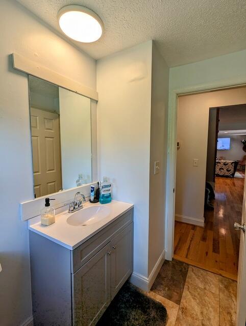 221 Camp Creek Rd NW, Riner, VA 24149 - bathroom featuring vanity and a textured ceiling