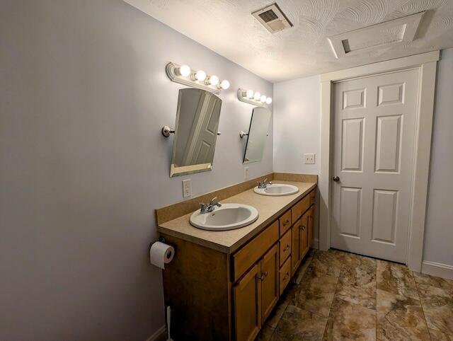 221 Camp Creek Rd NW, Riner, VA 24149 - bathroom with double vanity and baseboards