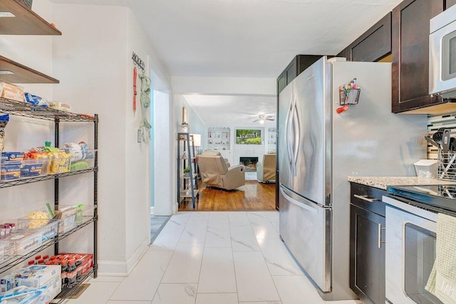105 Barnette Rd, Salem, VA 24153 - kitchen with appliances with stainless steel finishes, a ceiling fan, light marble finish flooring, a fireplace, and open floor plan