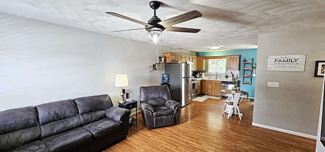 2610 Plantation Rd NE, Roanoke, VA 24012 - living area with ceiling fan, wood finished floors, and a textured ceiling