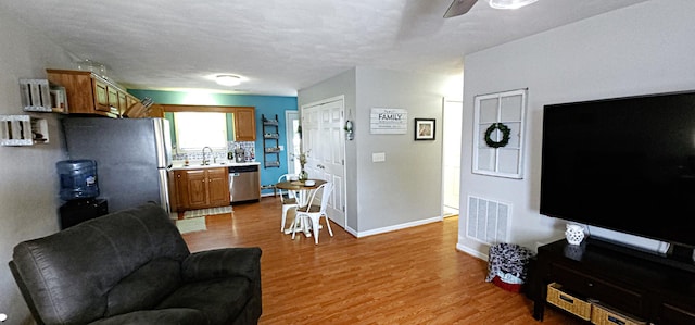 2610 Plantation Rd NE, Roanoke, VA 24012 - living area with light wood-style floors and a ceiling fan