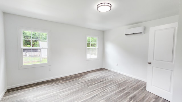 801 Concord St, Selma, VA 24474 - empty room with an AC wall unit and light wood-style flooring