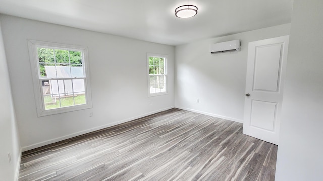 801 Concord St, Selma, VA 24474 - spare room with a wall mounted AC, plenty of natural light, and wood finished floors