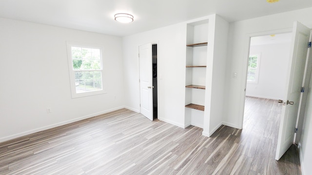 801 Concord St, Selma, VA 24474 - unfurnished bedroom featuring light wood-style flooring and multiple windows