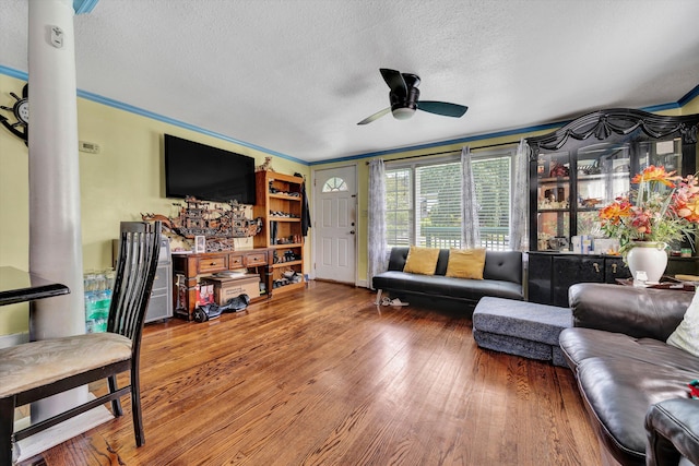 3653 Bunker Hill Dr, Roanoke, VA 24018 - living room featuring ceiling fan, a textured ceiling, wood finished floors, crown molding, and ornate columns