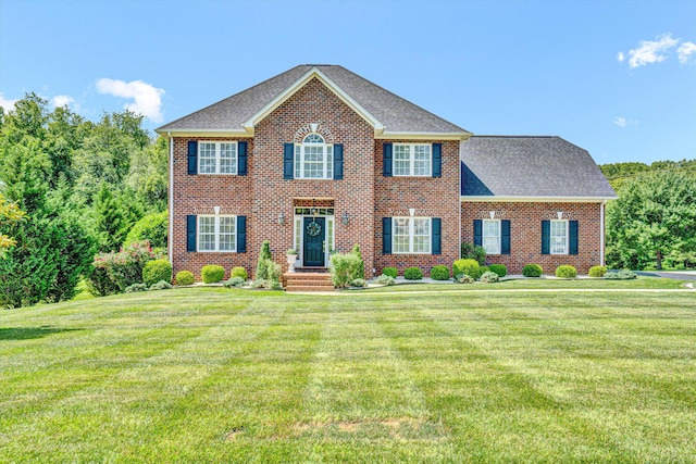 1258 Colby Dr, Forest, VA 24551 - colonial-style house featuring a front yard, brick siding, and roof with shingles