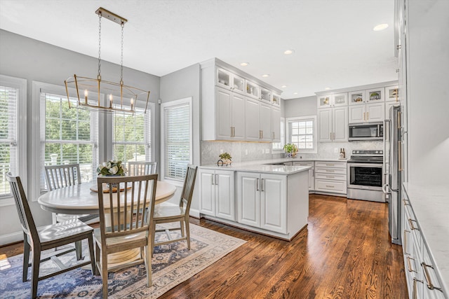 1258 Colby Dr, Forest, VA 24551 - kitchen featuring stainless steel appliances, a chandelier, dark wood-type flooring, decorative backsplash, and white cabinets