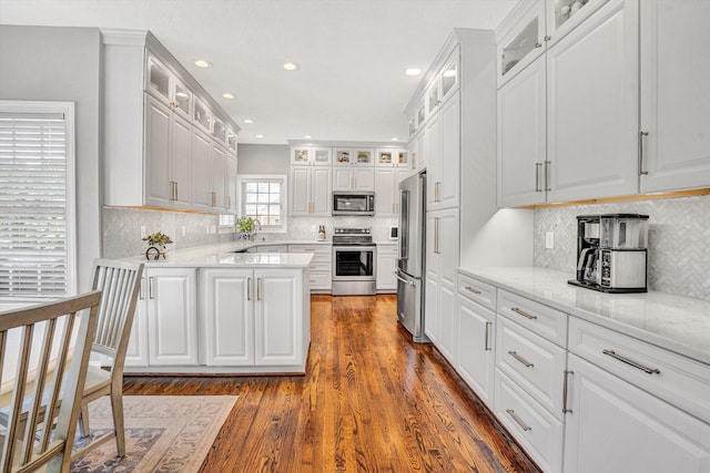 1258 Colby Dr, Forest, VA 24551 - kitchen featuring appliances with stainless steel finishes, a peninsula, dark wood finished floors, recessed lighting, and white cabinetry