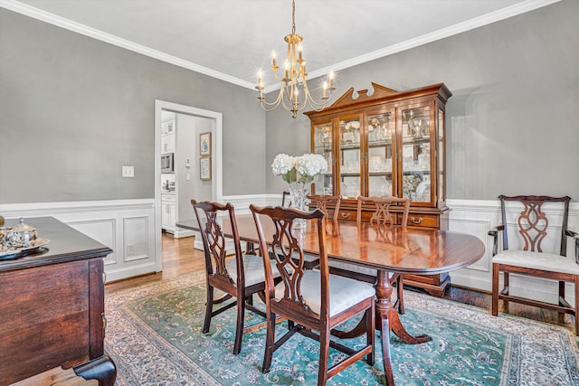 1258 Colby Dr, Forest, VA 24551 - dining area with a chandelier, light wood-style floors, wainscoting, and crown molding