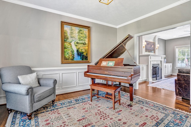 1258 Colby Dr, Forest, VA 24551 - sitting room featuring wood finished floors, ornamental molding, a wainscoted wall, and a fireplace with flush hearth