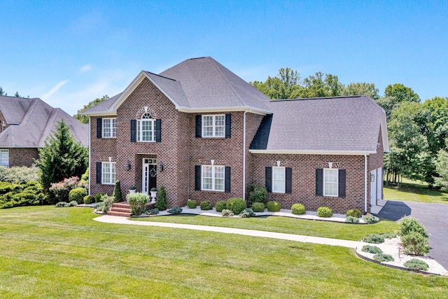 1258 Colby Dr, Forest, VA 24551 - colonial home with brick siding, a front lawn, a garage, and roof with shingles